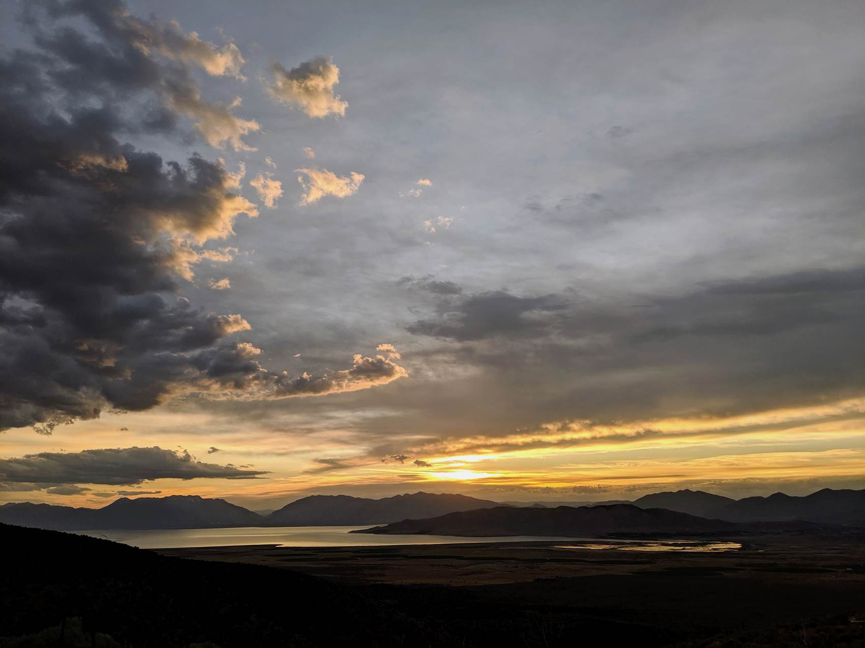 Golden sunset over a lake and mountain valley